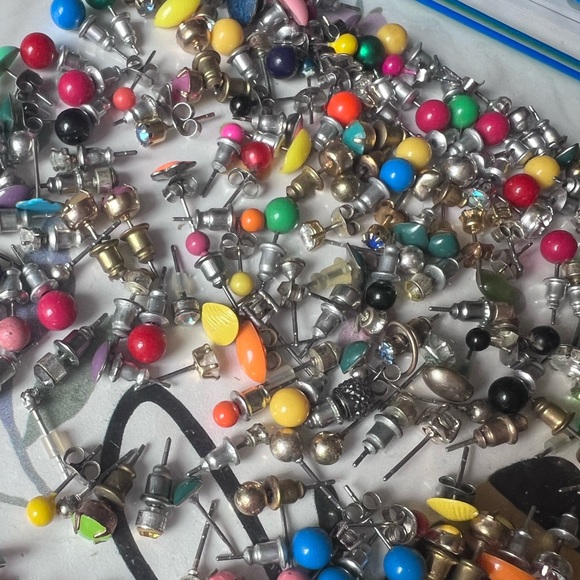 Bag full of different colored stud earrings. - Picture 11 of 13